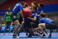 The South Korean women's team tackling a Bangladeshi player in group stage match of Asian Games 2014.